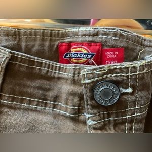 Womens Dickies pants, cargo look, size 11/30, and color brown/tan.
